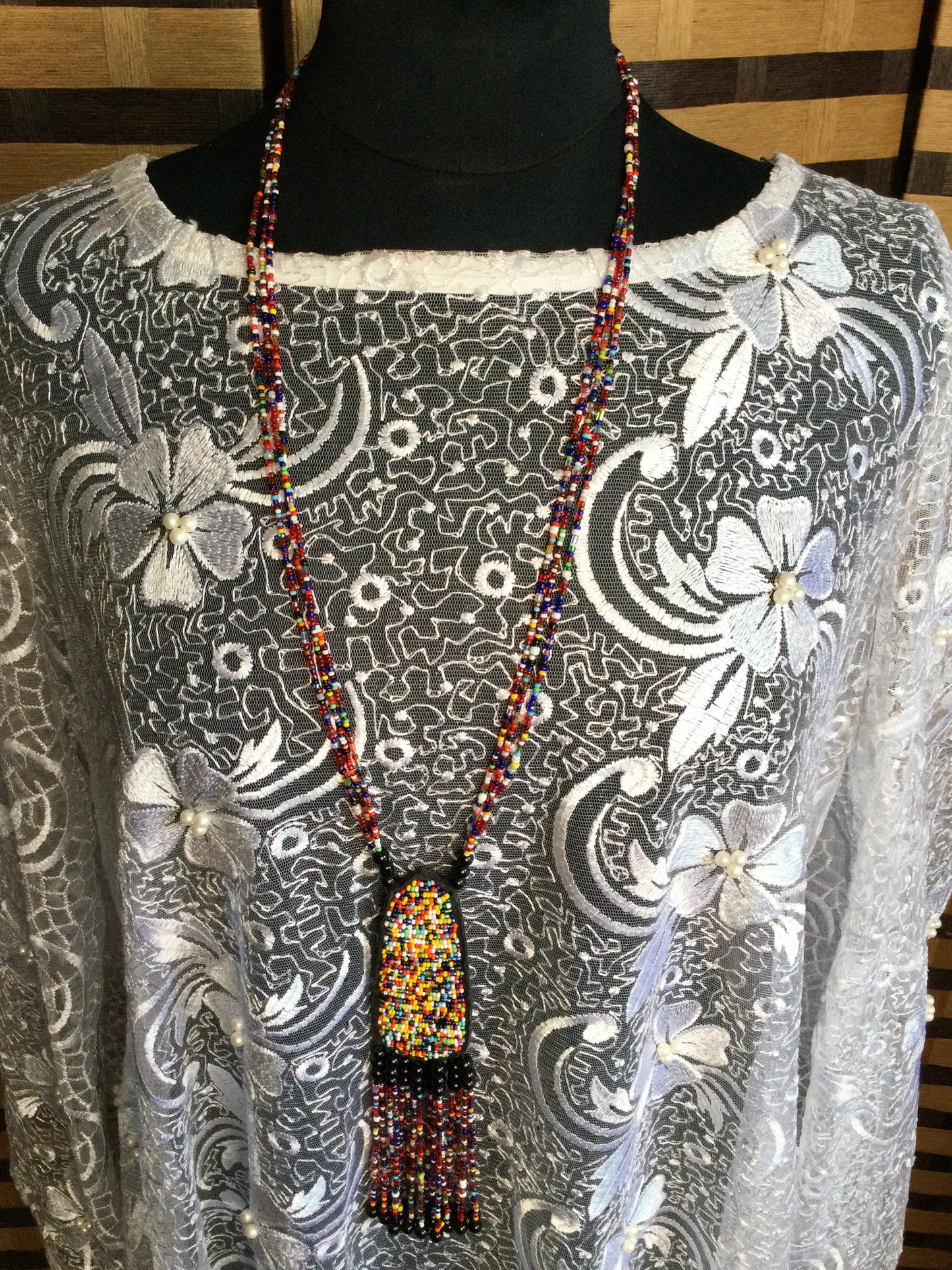 Long Strand beaded necklace with leather and beads pendant