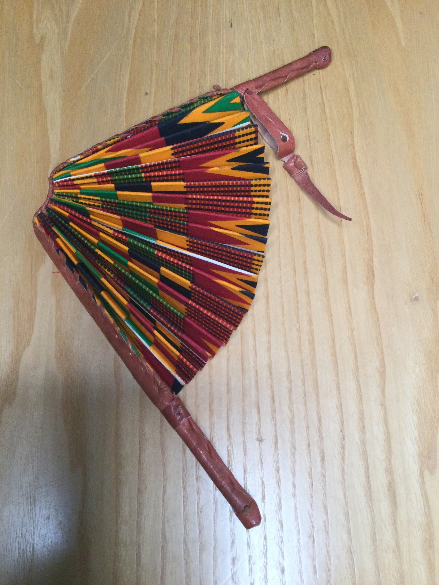 Hand held fan crafted with Delightfully bright African print