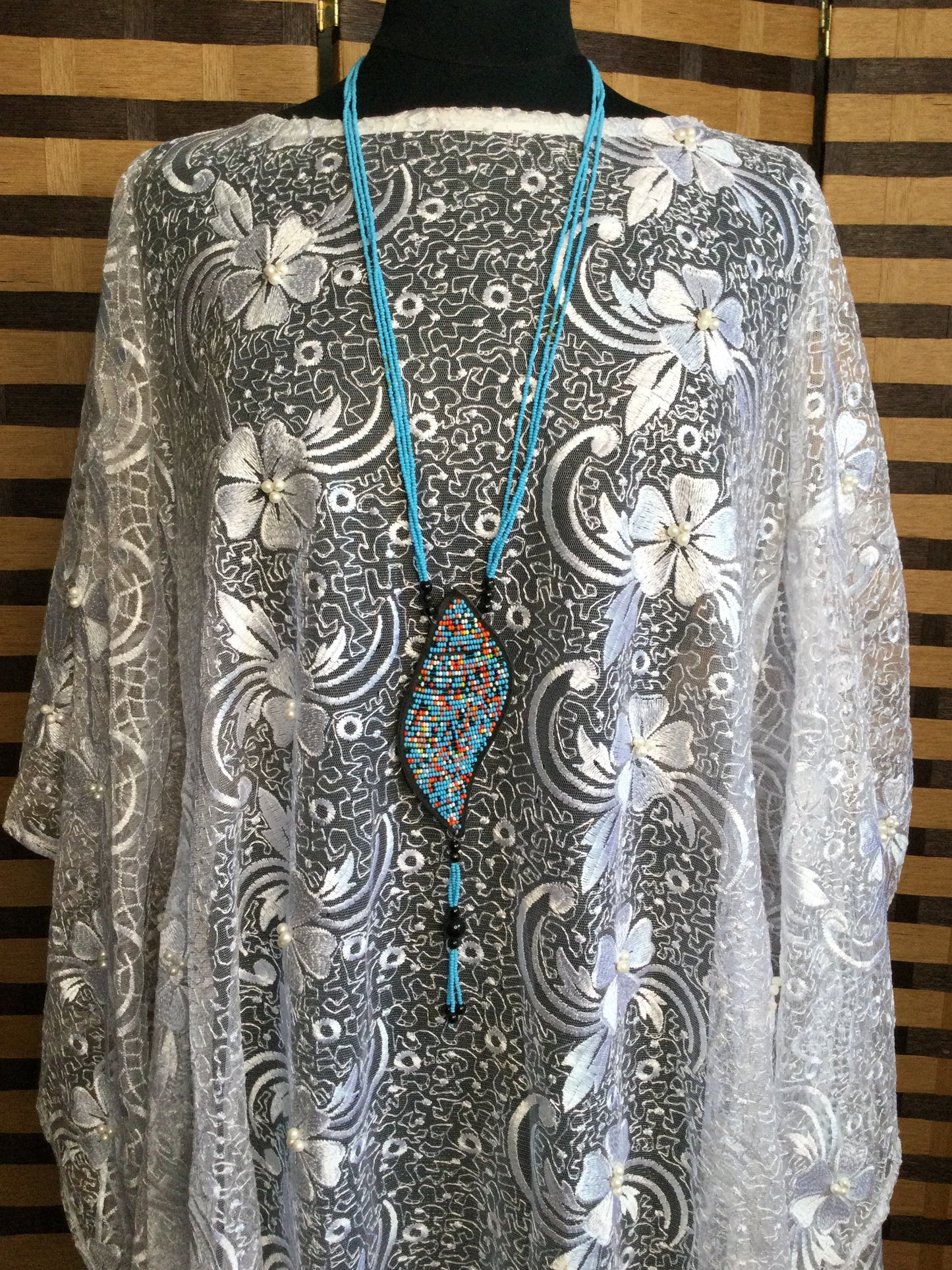 Long Strand beaded necklace with leather and beads pendant